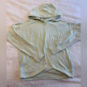 Athleta Girl light green pullover hoodie with a criss-cross hem detail Size L